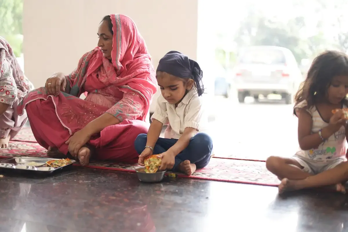 Children enjoying Sunday Pizza Langar