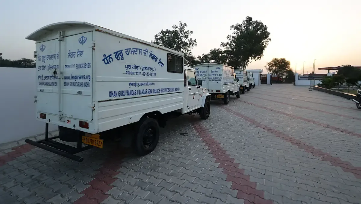 Langar vehicles at the Madhir kitchen at sunset