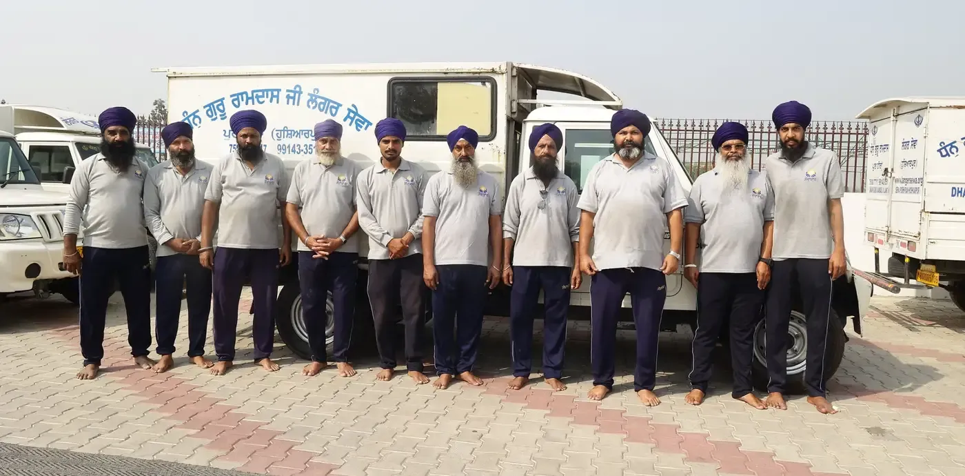 Sewadars of the Pur Heeran kitchen with a Langar vehicle
